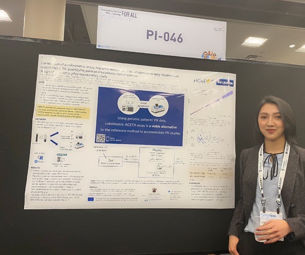 Young asian women standing next to her research poster.