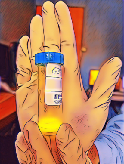 An artistic, digitally enhanced image portrays a hand holding a small, transparent medical vial with a blue cap and a label, possibly containing a yellow substance. The image is given a vivid, glowing outline effect, emphasizing the colors and contours of the hand and the vial in a striking, illustrative manner.